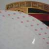 A close up of the porsche logo on a car.
