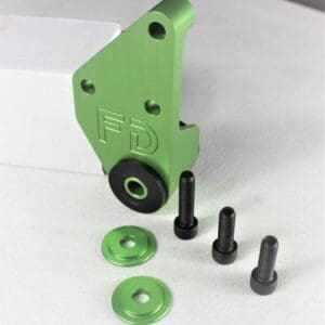 A green and black piece of metal with some bolts